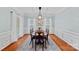 Traditional dining room with wood table, area rug and bright natural lighting at 9624 Barnburgh Ln, Huntersville, NC 28078