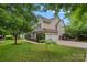 Two-story house with a well-manicured lawn and attached two car garage at 9624 Barnburgh Ln, Huntersville, NC 28078