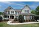 Beautiful brick two-story home with black shutters and landscaped front yard at 9624 Barnburgh Ln, Huntersville, NC 28078