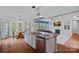 Open kitchen and living area with hardwood floors, stainless steel appliances, and a large kitchen island at 9624 Barnburgh Ln, Huntersville, NC 28078