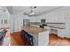 Spacious eat-in kitchen with large island, granite countertops, stainless steel appliances, and white cabinets at 9624 Barnburgh Ln, Huntersville, NC 28078