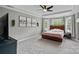 Primary bedroom with neutral walls, plush carpeting, a large window and stylish decor at 9624 Barnburgh Ln, Huntersville, NC 28078