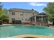Back of house, screened-in porch, and a pool, offer a serene and private outdoor entertainment space at 9624 Barnburgh Ln, Huntersville, NC 28078