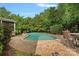 Backyard pool surrounded by a brick patio and lush greenery providing a private oasis for relaxation at 9624 Barnburgh Ln, Huntersville, NC 28078