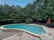 Backyard with private mature landscaping, a pool, brick paving, and patio furniture at 9624 Barnburgh Ln, Huntersville, NC 28078
