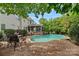 Inviting pool and patio area offers a peaceful retreat with mature trees and comfortable seating options at 9624 Barnburgh Ln, Huntersville, NC 28078