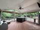 Spacious screened-in porch with wicker furnishings overlooking backyard pool at 9624 Barnburgh Ln, Huntersville, NC 28078