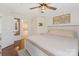 Comfortable bedroom with a ceiling fan, hardwood floors and a stylish wooden frame bed, leading into bathroom at 108 Pier 33 Dr # 414, Mooresville, NC 28117