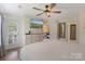 Bright bedroom with hardwood flooring, ceiling fan, and large dresser featuring a door leading to an outdoor space at 108 Pier 33 Dr # 414, Mooresville, NC 28117