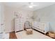 Charming Bedroom with light-colored walls, white crib, rocking chair, and hardwood floors at 108 Pier 33 Dr # 414, Mooresville, NC 28117
