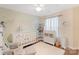 Charming Bedroom featuring a crib, dresser, rocking chair, and wood floors at 108 Pier 33 Dr # 414, Mooresville, NC 28117