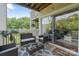 Cozy deck with woven furniture set, outdoor rug, and sliding glass door leading indoors at 108 Pier 33 Dr # 414, Mooresville, NC 28117