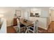 Open dining area leads to the kitchen with wooden table and seating for four at 108 Pier 33 Dr # 414, Mooresville, NC 28117