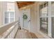 Front porch with a decorated door and welcome mat at 108 Pier 33 Dr # 414, Mooresville, NC 28117