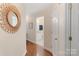Hallway with wooden floors, leading to a bathroom with granite countertop at 108 Pier 33 Dr # 414, Mooresville, NC 28117