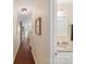 Hallway leading to bathroom with granite top vanity and hardwood floors at 108 Pier 33 Dr # 414, Mooresville, NC 28117
