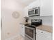 Well-lit kitchen showcasing stainless steel oven and microwave, granite counters, and white cabinets at 108 Pier 33 Dr # 414, Mooresville, NC 28117