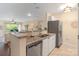 Bright kitchen featuring stainless steel appliances and a granite countertop at 108 Pier 33 Dr # 414, Mooresville, NC 28117