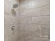 Modern shower featuring light beige tiling, stainless steel shower head and faucet hardware at 108 Pier 33 Dr # 414, Mooresville, NC 28117