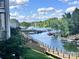 Expansive water view featuring a wooden walkway, boat docks and lush trees under a partly cloudy blue sky at 108 Pier 33 Dr # 414, Mooresville, NC 28117
