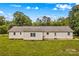 Rear view of home showcasing the home's vinyl siding and manicured backyard at 115 Three Oaks Ln, Statesville, NC 28677