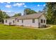 Back view of home showcasing the home's vinyl siding and spacious backyard at 115 Three Oaks Ln, Statesville, NC 28677