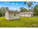 A large backyard features a shed with lots of green grass and mature trees at 115 Three Oaks Ln, Statesville, NC 28677