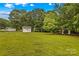 Expansive backyard featuring a shed and lush greenery, ideal for outdoor activities and relaxation at 115 Three Oaks Ln, Statesville, NC 28677