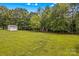 A large, well-maintained backyard with a shed and bordered by mature trees offers a peaceful and private outdoor space at 115 Three Oaks Ln, Statesville, NC 28677