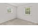 Bedroom featuring neutral carpet, two windows, and a ceiling fan at 115 Three Oaks Ln, Statesville, NC 28677