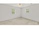 Bedroom with natural light, featuring neutral carpet and two windows at 115 Three Oaks Ln, Statesville, NC 28677