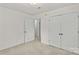 Bedroom with double door closet, neutral carpet, and access to the hallway at 115 Three Oaks Ln, Statesville, NC 28677