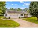 Charming home features a well-manicured lawn and attached two-car garage at 115 Three Oaks Ln, Statesville, NC 28677