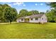 Well-maintained home with manicured front lawn, shutters, and shade trees at 115 Three Oaks Ln, Statesville, NC 28677