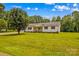 Charming home with manicured front yard, black shutters, and landscaping at 115 Three Oaks Ln, Statesville, NC 28677