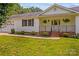 Charming front porch with brick steps and black railings and landscaped bushes at 115 Three Oaks Ln, Statesville, NC 28677