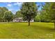 Large front lawn with mature trees and view of the front exterior at 115 Three Oaks Ln, Statesville, NC 28677