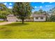 Home with a large front yard and mature shade tree plus an attached two-car garage at 115 Three Oaks Ln, Statesville, NC 28677