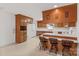 Charming kitchen with wood cabinets, breakfast bar, white appliances and a window over the sink at 115 Three Oaks Ln, Statesville, NC 28677