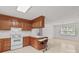 Traditional kitchen with wood cabinets, white appliances, and a breakfast bar at 115 Three Oaks Ln, Statesville, NC 28677