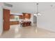 Spacious eat-in kitchen featuring wood cabinets, breakfast bar, tile floors, and modern lighting at 115 Three Oaks Ln, Statesville, NC 28677