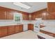 Functional kitchen featuring wood cabinets, white appliances, tile flooring, and natural light at 115 Three Oaks Ln, Statesville, NC 28677