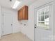Laundry room with storage cabinets and a white door to the exterior at 115 Three Oaks Ln, Statesville, NC 28677