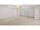 Bright living room with front entry door, ceiling fan, and neutral carpet and paint at 115 Three Oaks Ln, Statesville, NC 28677