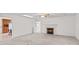 Bright living room with a decorative fireplace, ceiling fan and access to the kitchen area at 115 Three Oaks Ln, Statesville, NC 28677