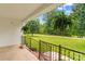Inviting porch with ferns and black metal railing overlooking a well-manicured lawn and scenic views at 115 Three Oaks Ln, Statesville, NC 28677