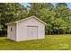 White outdoor storage shed with double doors and small window at 115 Three Oaks Ln, Statesville, NC 28677