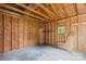 Unfinished shed interior with a concrete floor and wood stud walls offers customization for storage or workshop space at 115 Three Oaks Ln, Statesville, NC 28677
