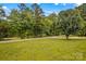 A large yard with beautiful green grass and tall mature trees at 115 Three Oaks Ln, Statesville, NC 28677