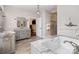 Bright bathroom with marble countertops, tiled floor, soaking tub, and glass enclosed shower at 118 Sunrise Cir, Mooresville, NC 28117